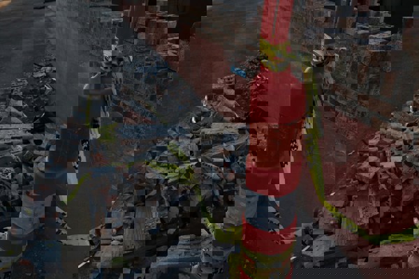 Construction debris and caution tape highlighting hazards and access risks on a site.